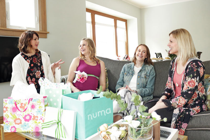 baby shower picture - women in a circle talking with numa kit in the foreground